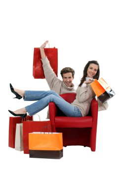 Couple posing with their shopping bags clipart