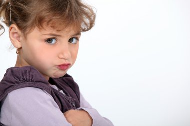 A little girl pouting. clipart