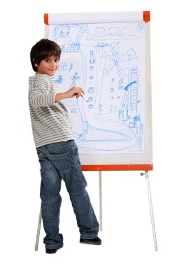 A little boy drawing on a whiteboard clipart