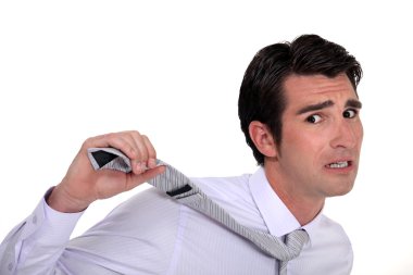 Businessman in panic pulling his tie clipart