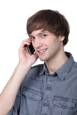 Young man on cellphone clipart