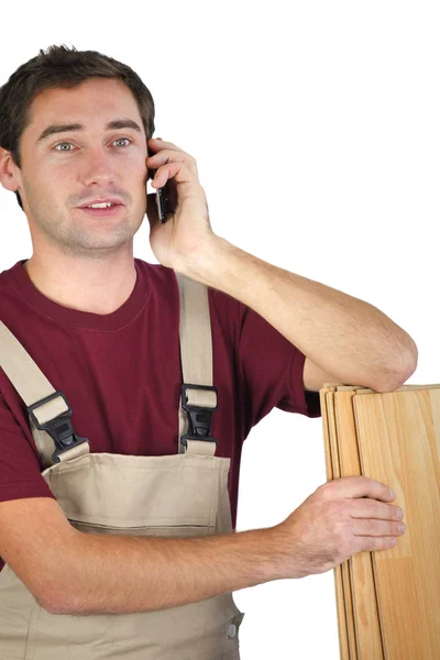 Carpenter talking on the phone — Stock Photo, Image