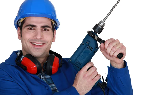 Tradesman holding up an electric screwdriver — Stock Photo, Image