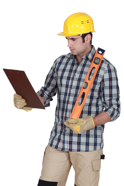 Handyman checking his clipboard. — Stock Photo, Image