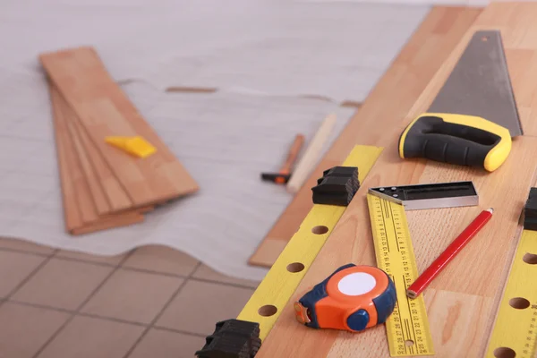 Tools on laminate flooring — Stock Photo, Image
