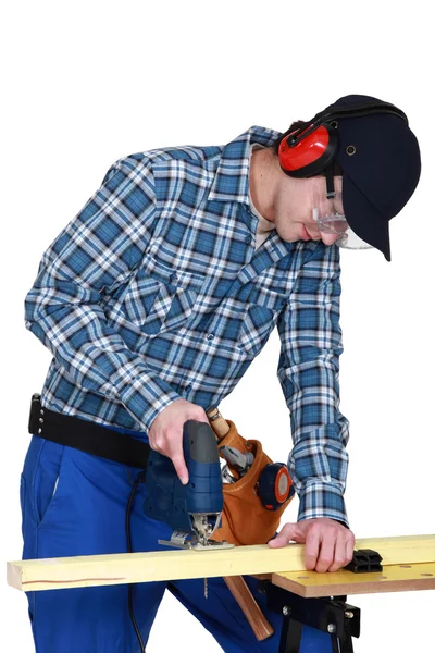 Woodworker using jigsaw — Stock Photo, Image