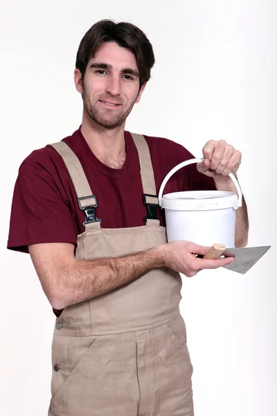 Man with a pot of grout — Stock Photo, Image