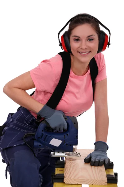 stock image Tradeswoman using a jigsaw