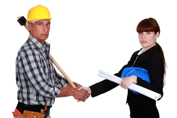 Construction workers handshaking — Stock Photo, Image