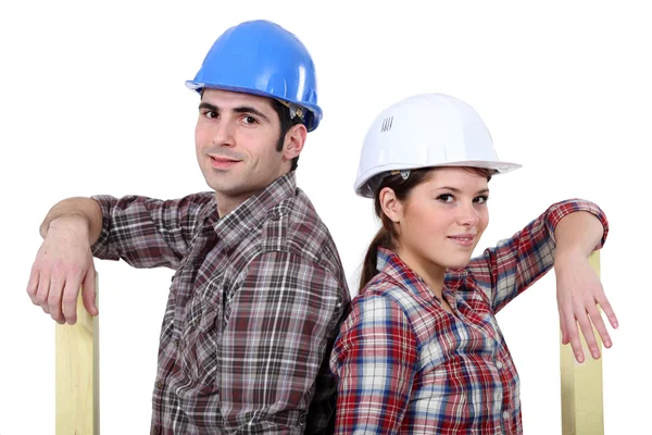 A couple of carpenters back to back. — Stock Photo, Image
