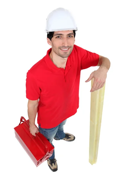Man met gereedschapskist en houten planken — Stockfoto