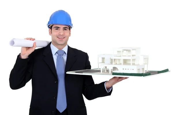 Architect with rolled-up plans and model housing — Stock Photo, Image