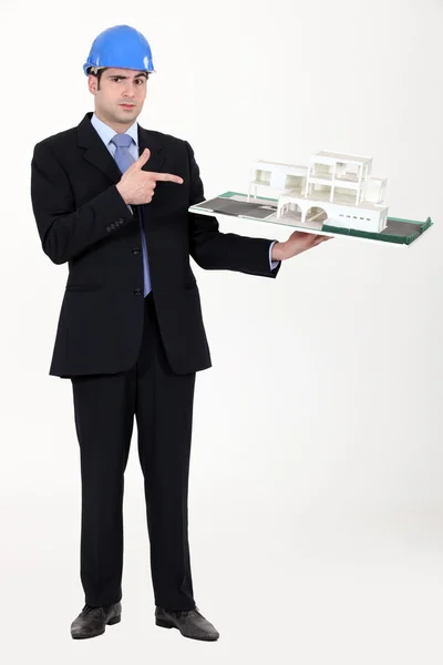 Architect pointing at his model. — Stock Photo, Image