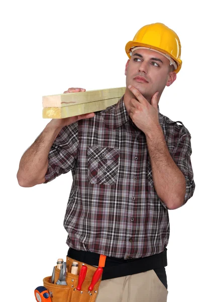 Portrait of handsome carpenter carrying lumber — Stock Photo, Image