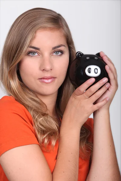 Woman with a piggy bank — Stock Photo, Image