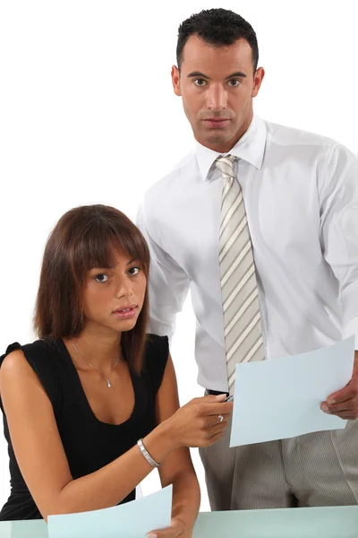 Business couple going over paperwork — Stock Photo, Image