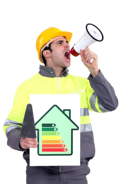 Man with energy rating poster shouting into megaphone — Stock Photo, Image