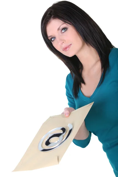 Email concept: Woman with an envelope marked @ — Stock Photo, Image
