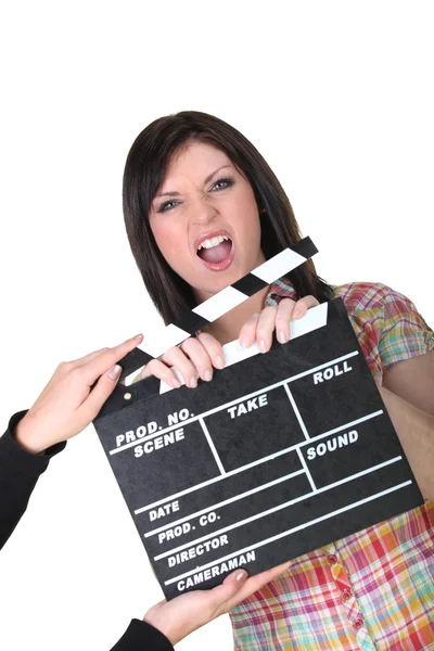 A woman having a hand caught in a movie clap — Stock Photo, Image