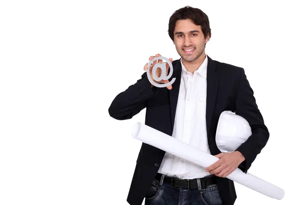 Businessman holding a blueprint and an at sign — Stock Photo, Image