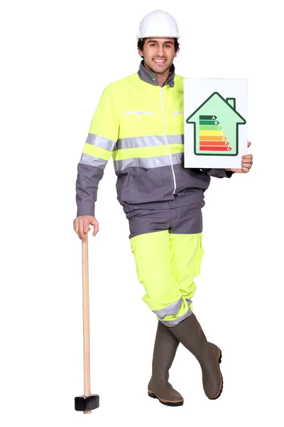 Craftsman holding an energy consumption label — Stock Photo, Image
