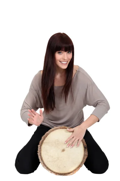 Woman banging a bongo — Stock Photo, Image