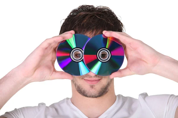 Junger Mann hält sich Compact Discs ins Gesicht — Stockfoto