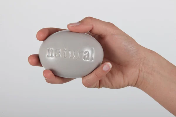 Hand holding soap marked 'natural' — Stock Photo, Image