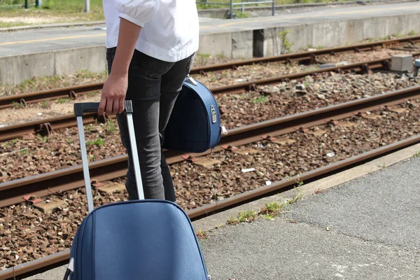 Žena s kufrem na stanici — Stock fotografie