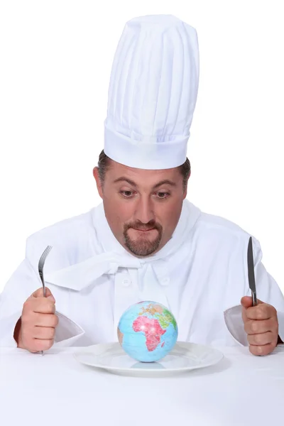 Cook with globe on a plate — Stock Photo, Image