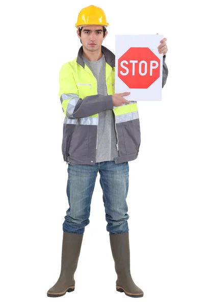 Bricklayer holding stop sign — Stock Photo, Image
