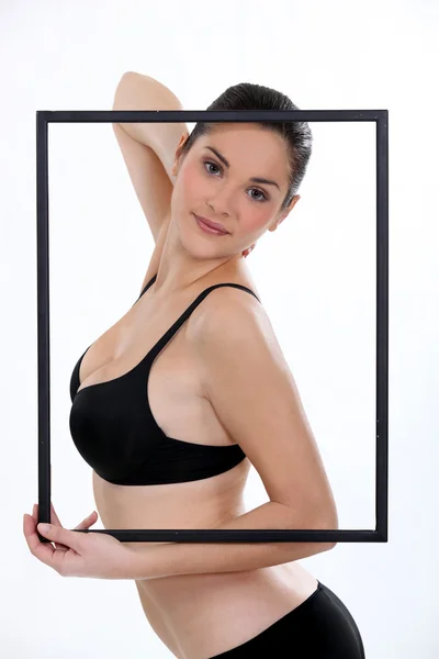 Woman in her underwear posing in a picture frame — Stock Photo, Image