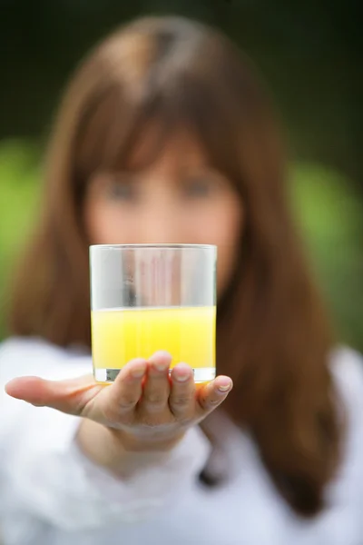 Woman holding a glass of range juice — Stock Photo, Image