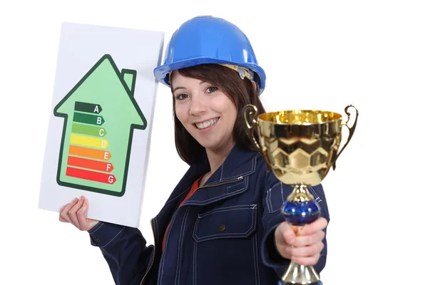 Woman with energy sign and trophy — Stock Photo, Image
