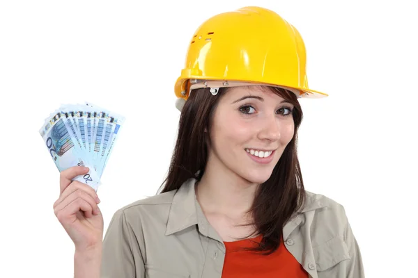 Young handy woman holding wage — Stock Photo, Image
