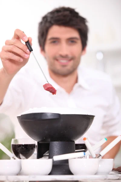 Young brunette eating fondue — Stock Photo, Image