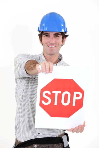 Trabalhador da construção com um sinal de stop — Fotografia de Stock