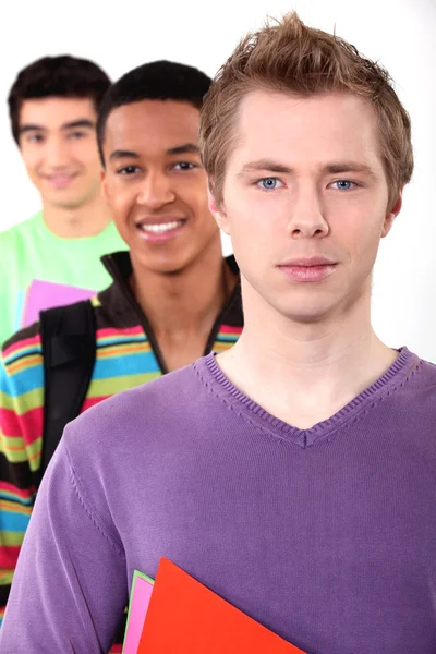 Tři studenti na bílém pozadí — Stock fotografie
