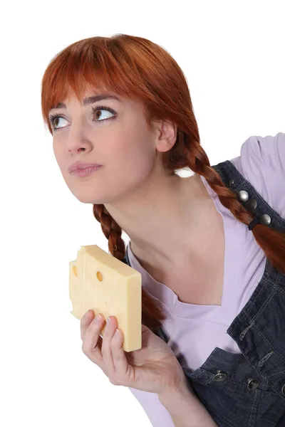 Woman with a block of Swiss cheese — Stock Photo, Image
