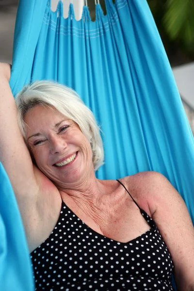 Senior woman laying on a hammock — Stock Photo, Image