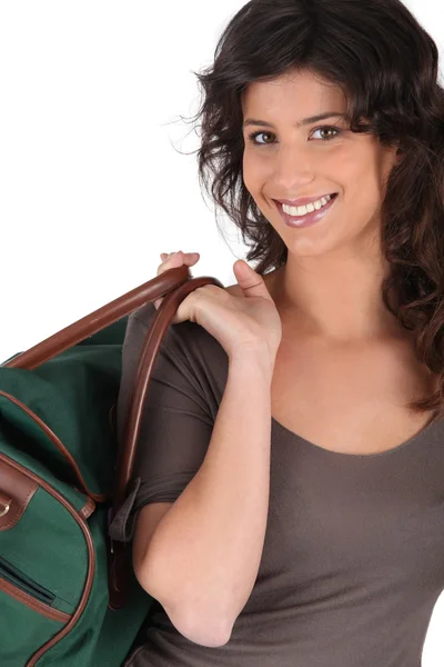 Woman carrying bag by handle — Stock Photo, Image