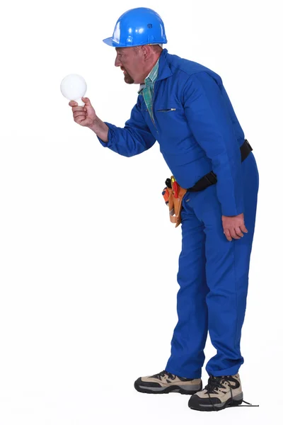 Electrocuted man staring at a light bulb — Stock Photo, Image