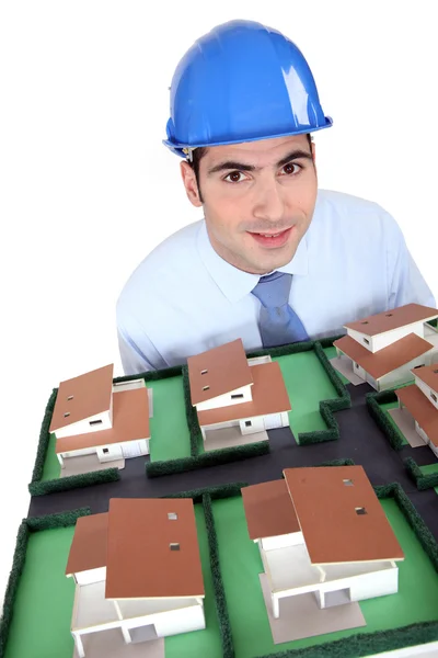 Businessman holding an architectural model — Stock Photo, Image