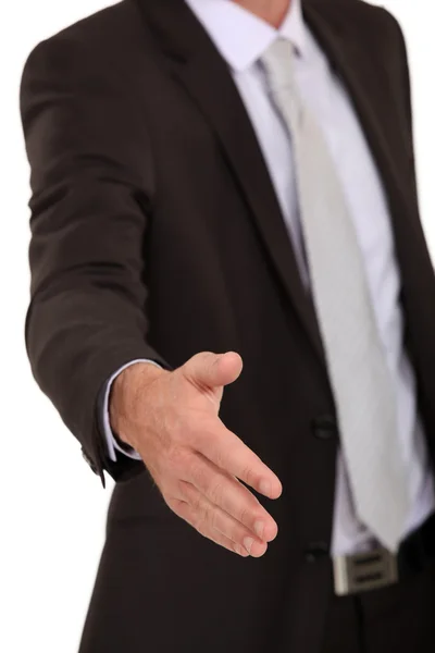 Businessman giving a hand for a handshake — Stock Photo, Image