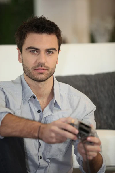 stock image Young man playing video games alone