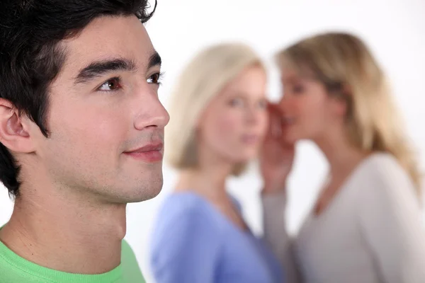 Women sharing secrets about young man — Stock Photo, Image