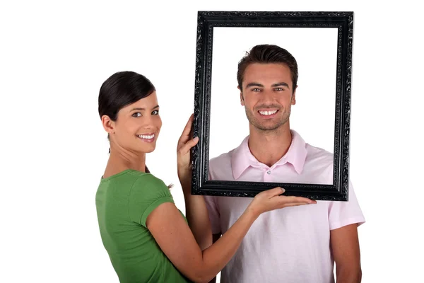 Casal segurando quadro de imagem em branco — Fotografia de Stock