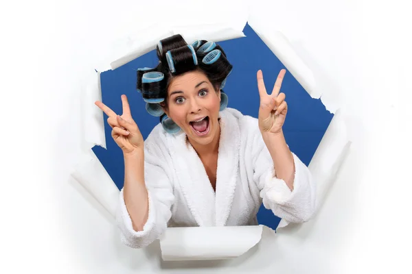 Crazy girl gesturing with bathrobe and hair curlers — Stock Photo, Image