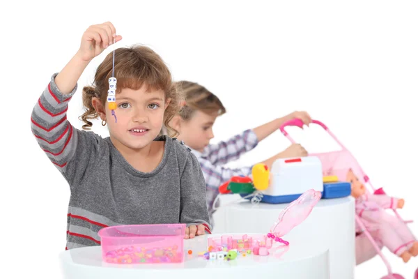 Little girls playing with toys — Stock Photo, Image