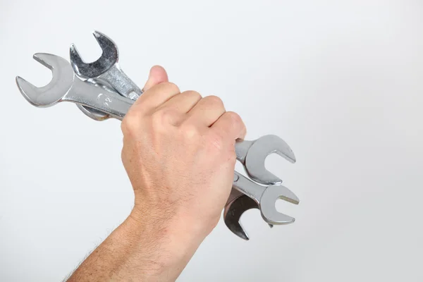 Closeup of a man's hand holding spanners — Stock Photo, Image